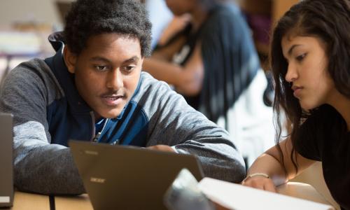 High school student working with classmate