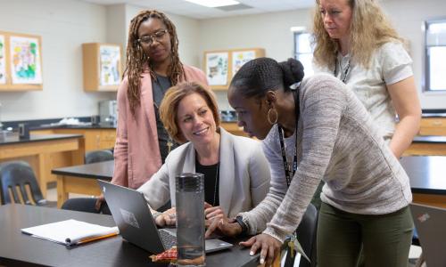 Teachers at a laptop