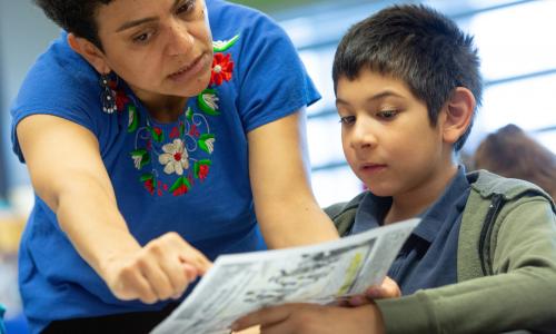 Teacher helping a boy