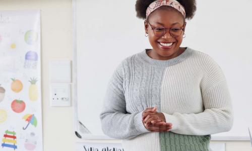 Teacher listening at front of room