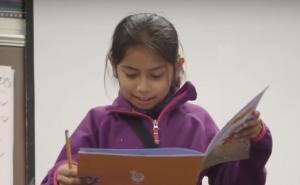 Student reading out loud from book