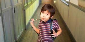Young boy with backpack at school