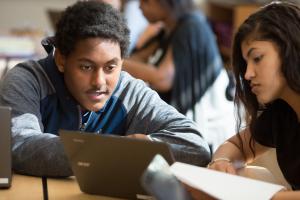 High school student working with classmate