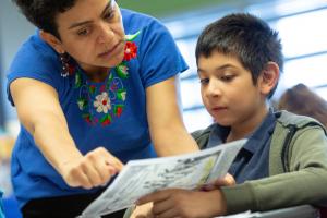 Teacher helping a boy