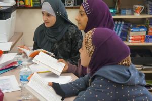 Three middle school girls discussing a book