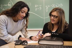 Teacher helping math student