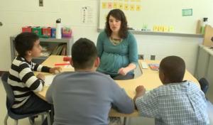 Teacher doing small group instruction with upper elementary students