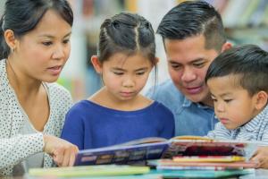 A family reading a book together.