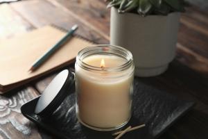 Candle with plant and notebook