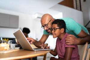 Father and son looking at laptop