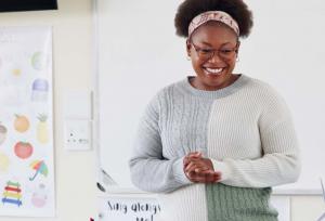 Teacher listening at front of room