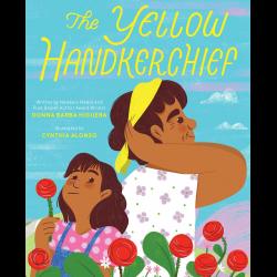 A girl looks off as her grandmother ties a yellow kerchief around her head