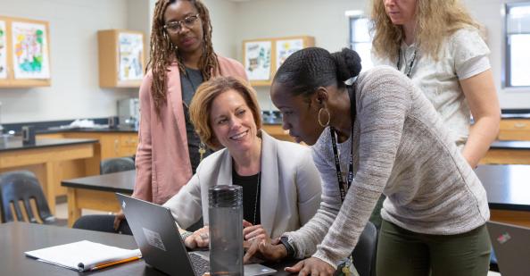 Teachers working in a group at a laptop