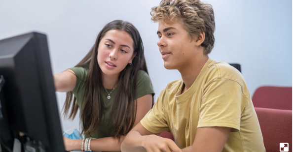 Two students looking at a computer