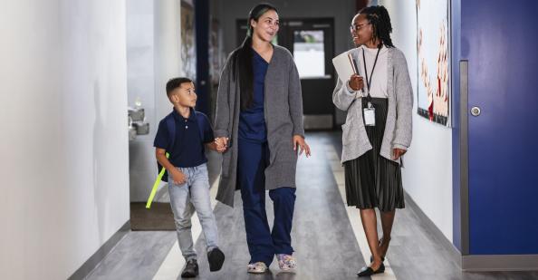 Mother and son talking to teacher