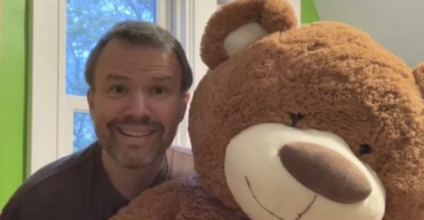 Principal with a giant teddy bear