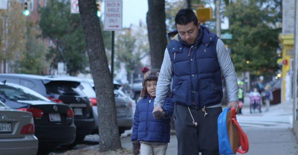 Young boy walking with father