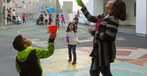 Teacher playing with student outside