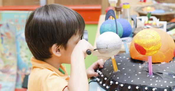 Student looking at model of planets